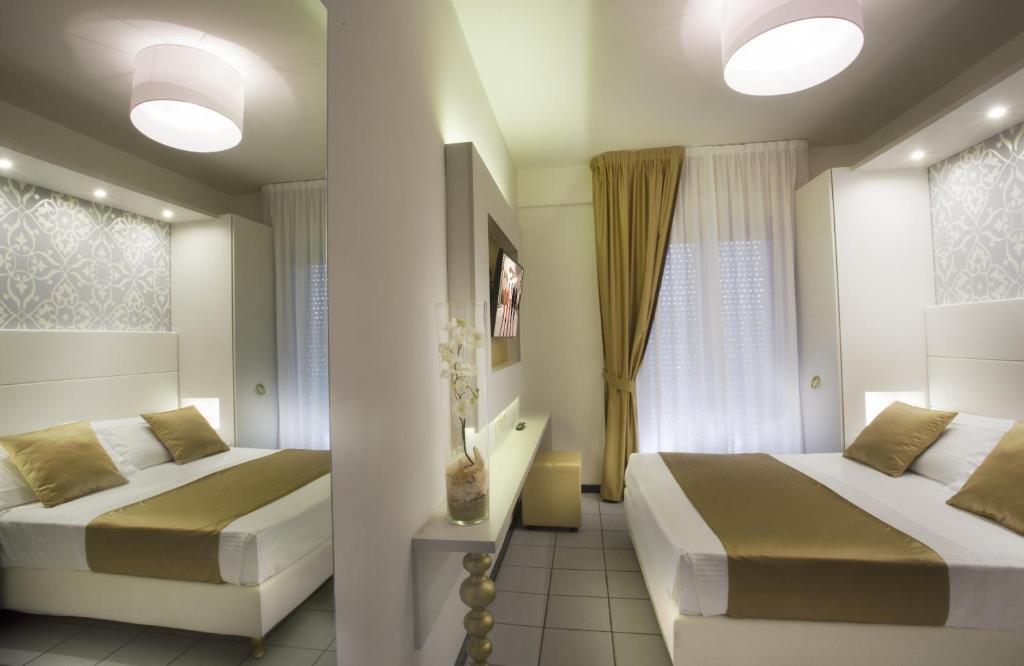Postel nebo postele na pokoji v ubytování Hotel Ambassador