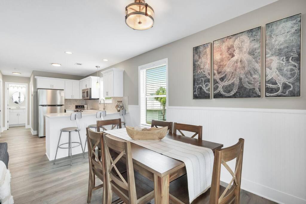 a kitchen and dining room with a table and chairs at Short walk or shuttle to wide open public beach! in Santa Rosa Beach