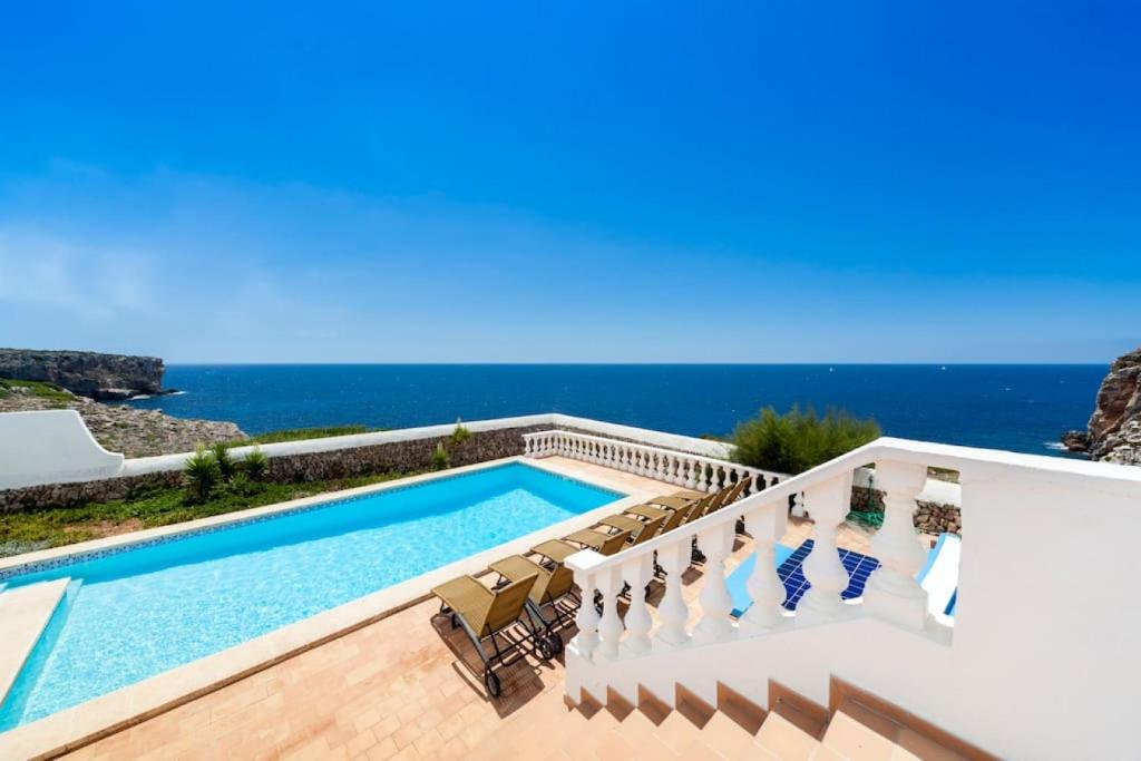 a swimming pool with a view of the ocean at Es Macar, warm pool in Es Canutells