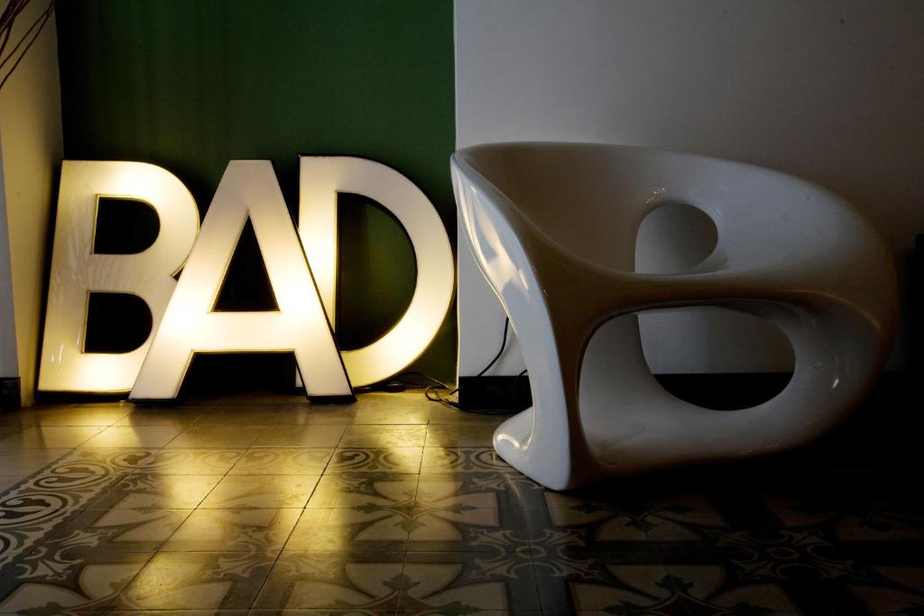 a bathroom with a toilet and a sign on the wall at BAD - B&B And Design in Catania