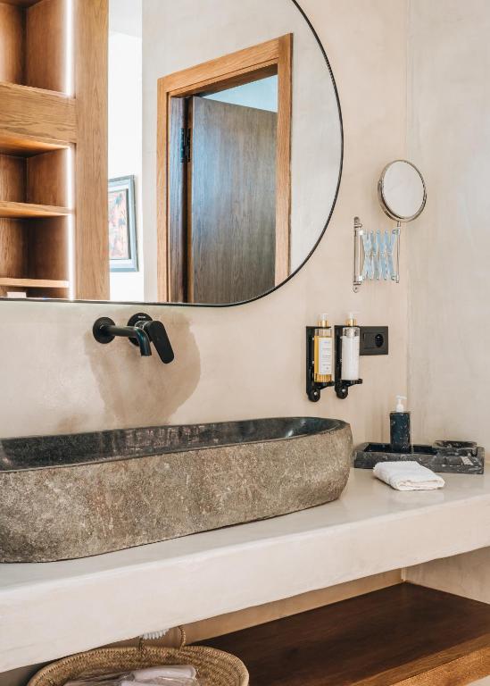 a bathroom with a stone tub and a mirror at Tulum Beach Resort Dakhla in Dakhla