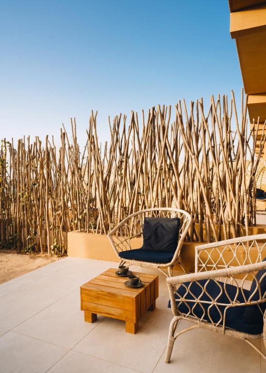a patio with two chairs and a coffee table at Tulum Beach Resort Dakhla in Dakhla
