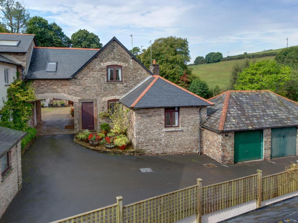 an aerial view of a house with a driveway at Brook Cottage in Newton Ferrers