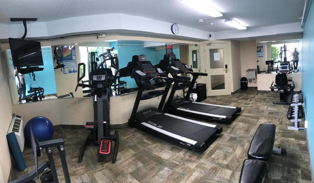a gym with treadmills and cardio equipment in a room at Howard Johnson Plaza by Wyndham by the Falls Niagara Falls in Niagara Falls
