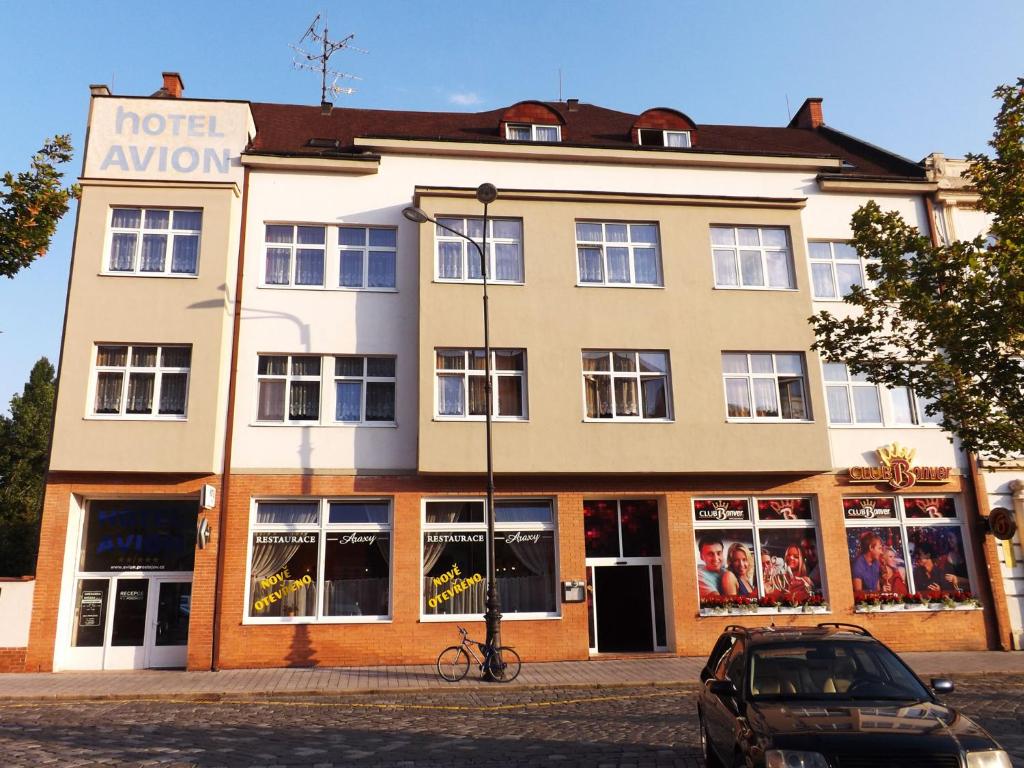ein Gebäude mit einem davor geparkt in der Unterkunft Hotel Avion in Prostějov