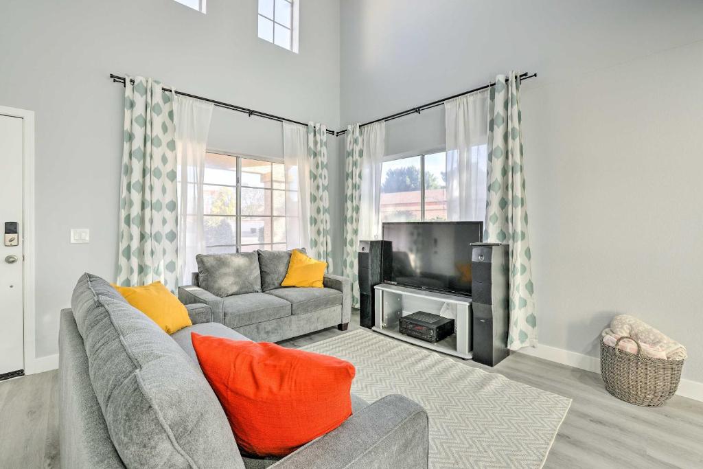 a living room with a couch and a tv at Chandler Home with Yard and Grill 3 Mi to Downtown! in Chandler