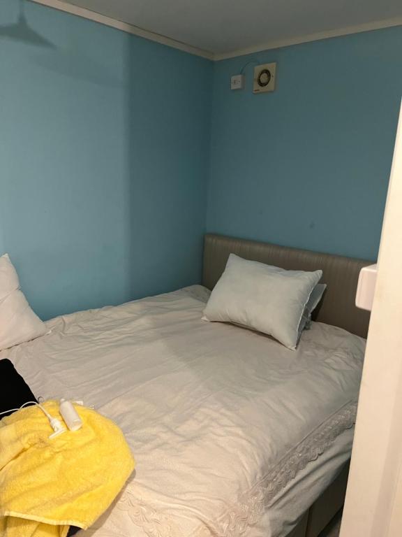 a bedroom with a bed with a yellow towel on it at Studio apartment in Bristol