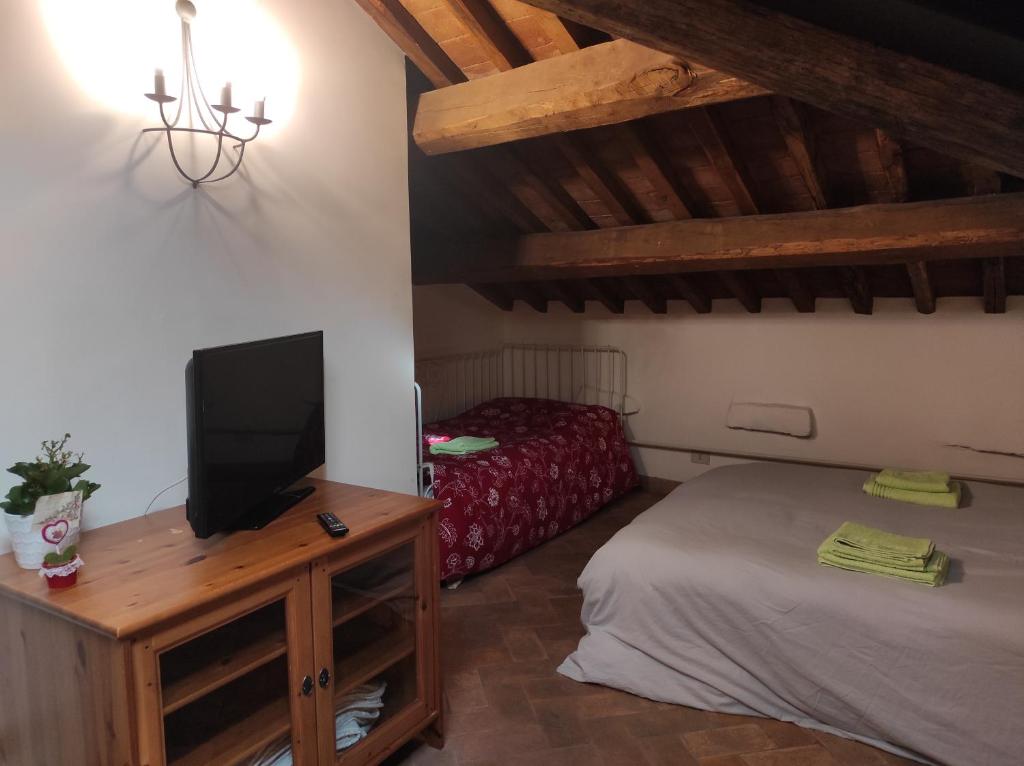 a bedroom with a bed and a tv on a table at Clockwise in Viterbo