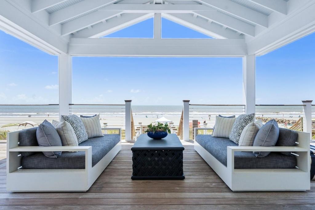 a porch with two couches and a view of the beach at 1001 E Arctic Out of the Blue Stunning Oceanfront Home in Folly Beach