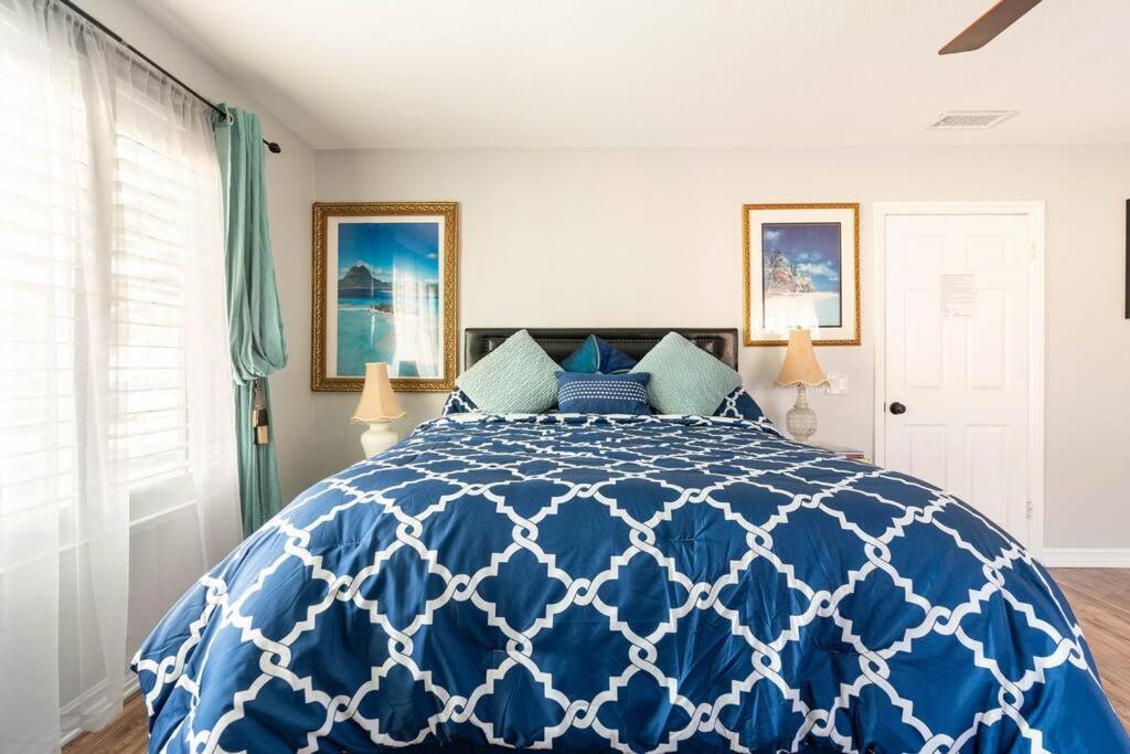 a blue and white bed in a room at Romantic Coastal Private Room in Oxnard