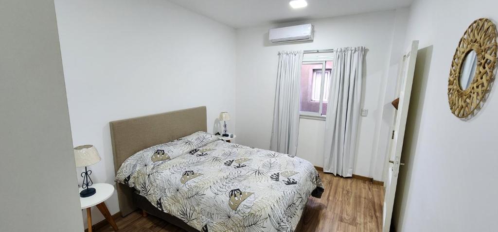 1 dormitorio con cama con edredón en COMPLEJO PALERMO SUITES en San Juan