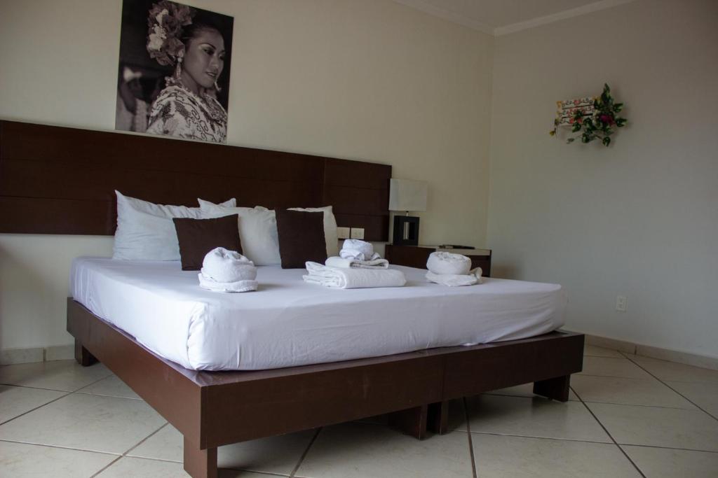 a bedroom with a large bed with towels on it at Hotel Eleven in Playa del Carmen
