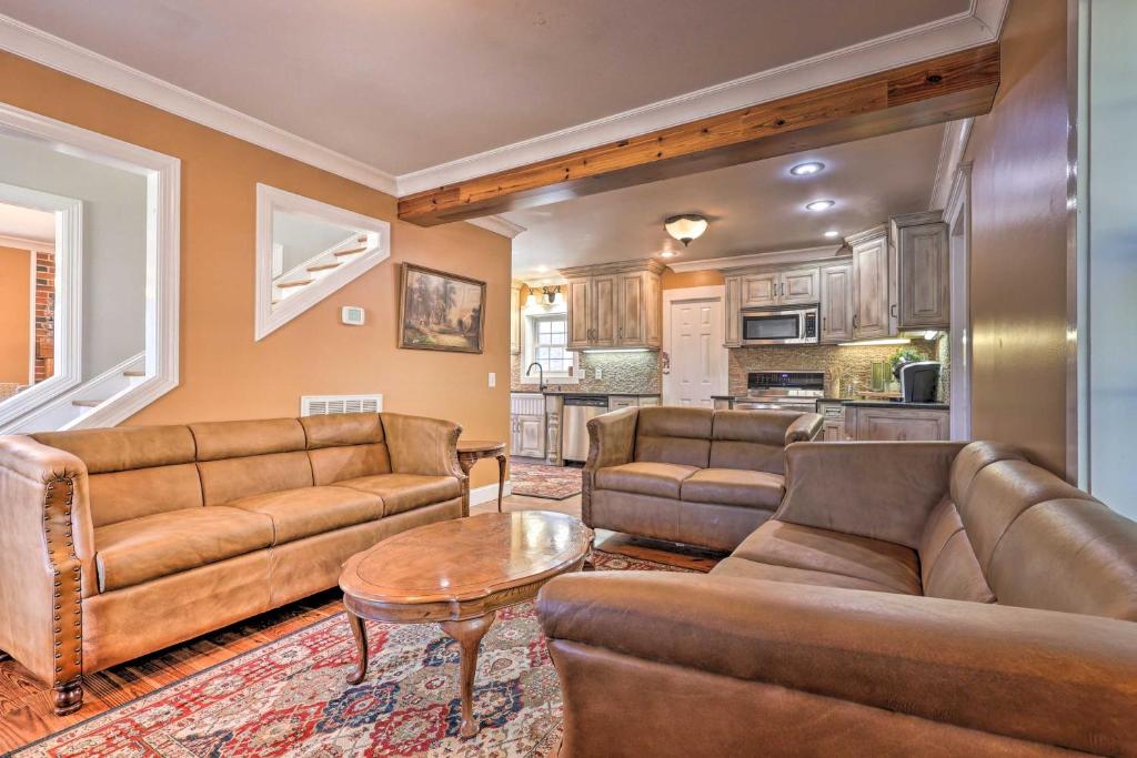 a living room with two couches and a table at Secluded Getaway Home with Trails and Waterfall! 