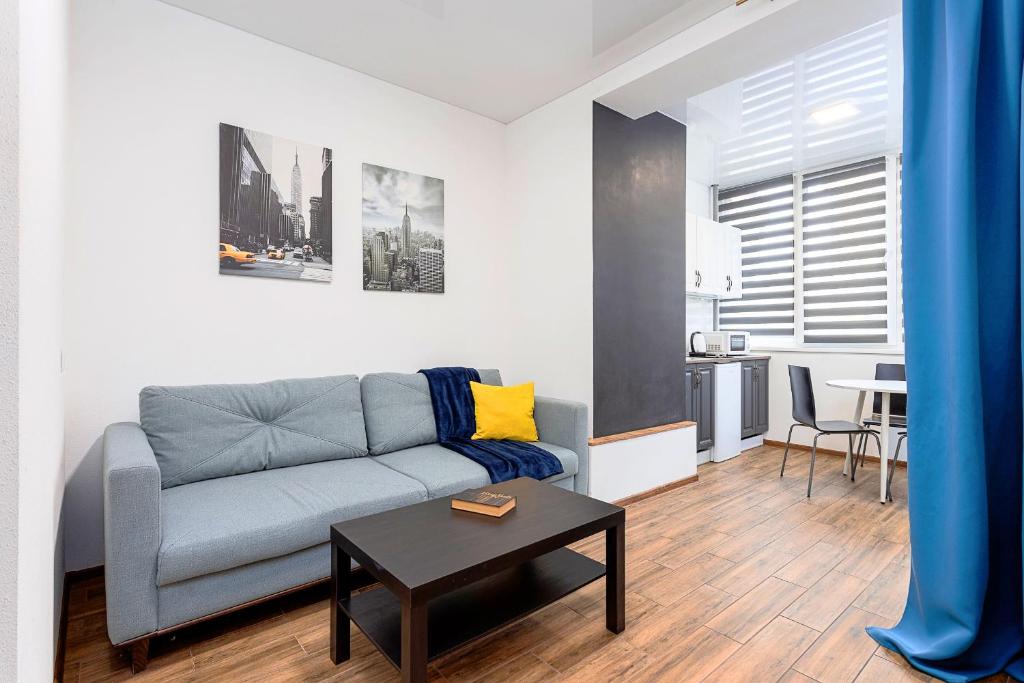 a living room with a couch and a table at 054 квартира ЖК Софія Резиденс, 1 поверх in Kyiv