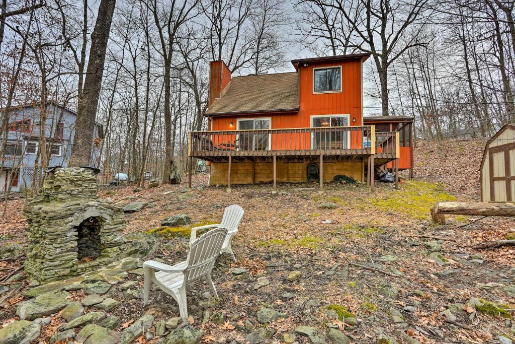 une maison orange avec deux chaises devant elle dans l'établissement Cozy Bushkill Cabin with Deck Near Shawnee Mountain!, à Bushkill