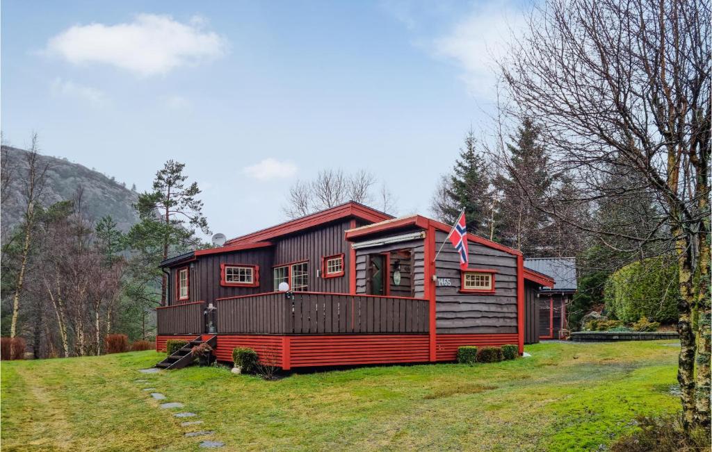 a red and black house on a grassy field at 2 Bedroom Awesome Home In Moi in Moi