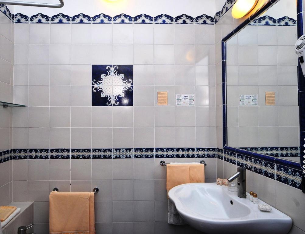 a bathroom with a sink and a mirror at Hotel Aura in Vulcano