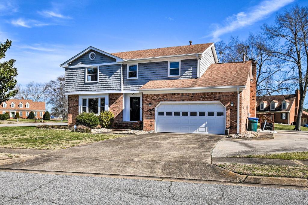 a large house with a garage on a street at Spacious Chesapeake Home with Pool Table! in Chesapeake