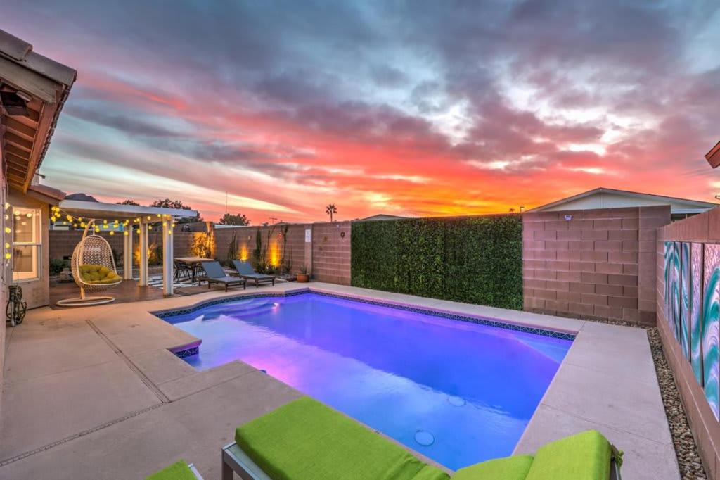 a swimming pool in the backyard of a house at Sunset Swim - Modern Vegas Heated Pool Retreat in Las Vegas
