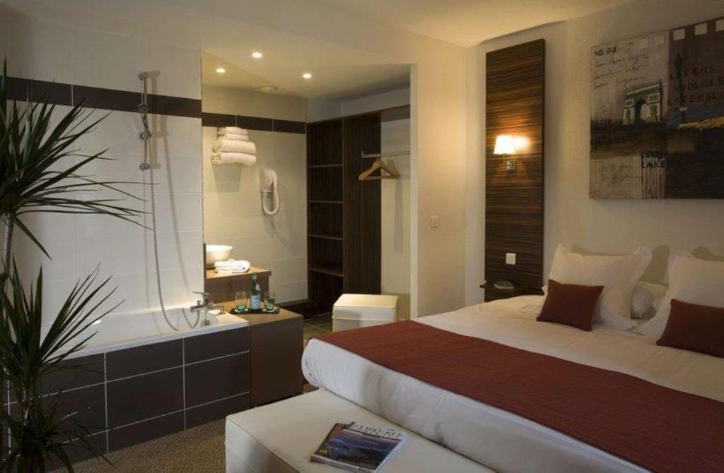 Postel nebo postele na pokoji v ubytování Hôtel Le Palladior Voiron