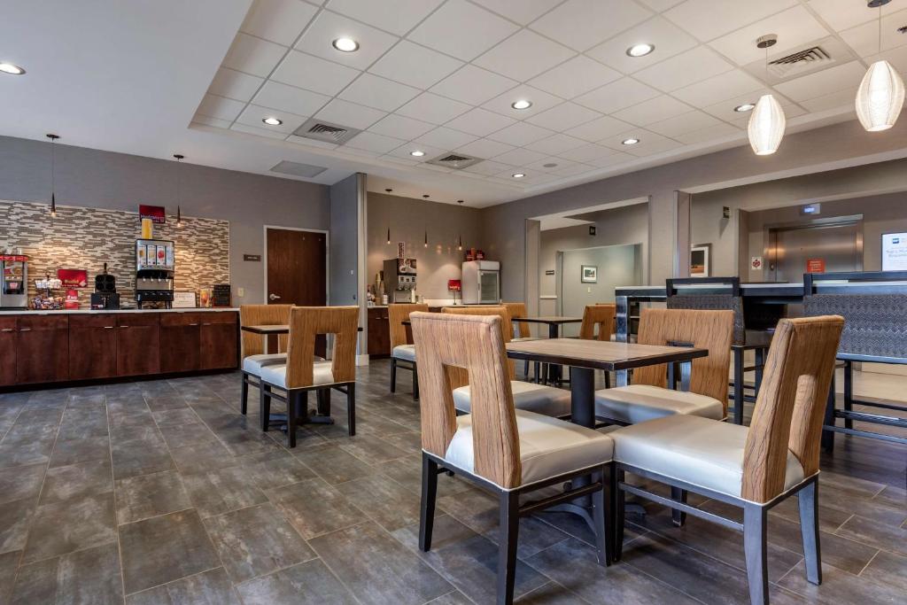 a restaurant with tables and chairs and a counter at Best Western Plus The Hammondsport Hotel in Hammondsport