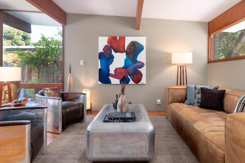 a living room with a couch and a table at Zen Meets Art Art Meets Luxury in Palo Alto