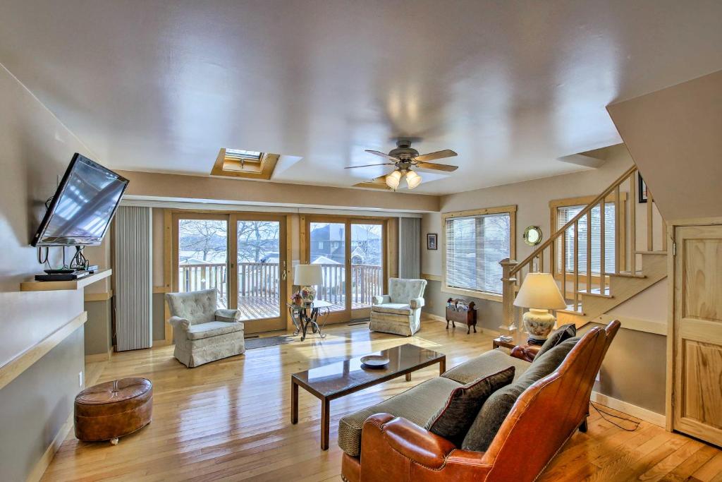 a living room with a couch and a table at Charming Lake Ripley Cottage with Water View! in Cambridge