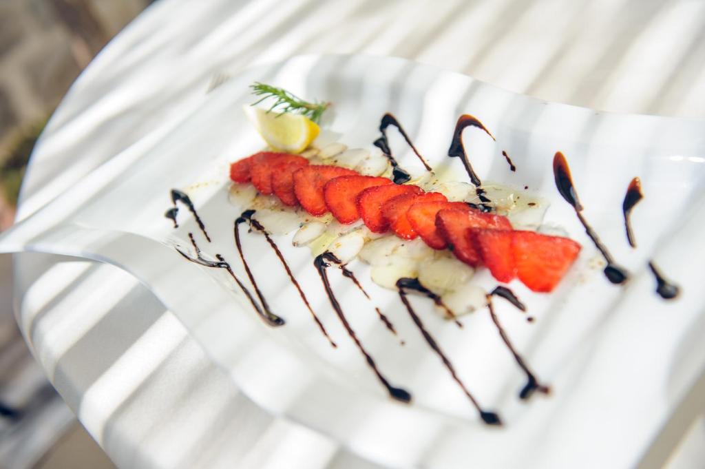 a plate of food with carrots with chocolate sauce at Hotel Azimut in Sveti Stefan