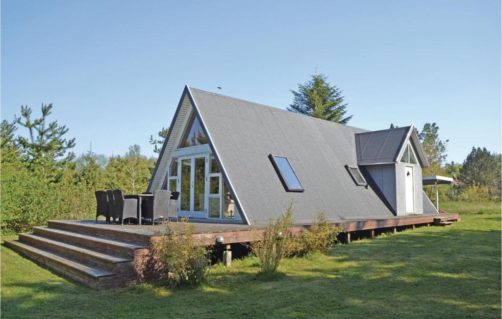 une petite maison avec un toit mansardé sur une terrasse dans l'établissement Gorgeous Home In Lgstr With Wifi, à Løgstør