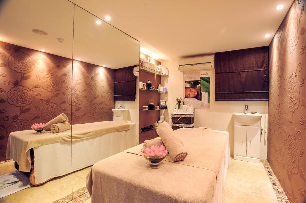 a room with two beds and a glass wall at Hotel Azimut in Sveti Stefan