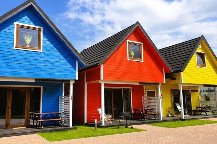 a colorful house is painted in different colors at Comfortable cottages, very close to the sea, G ski in Gąski