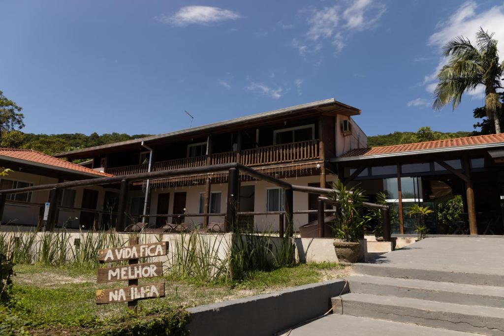 un bâtiment avec un panneau devant lui dans l'établissement Pousada Beira Mar, à Ilha do Mel