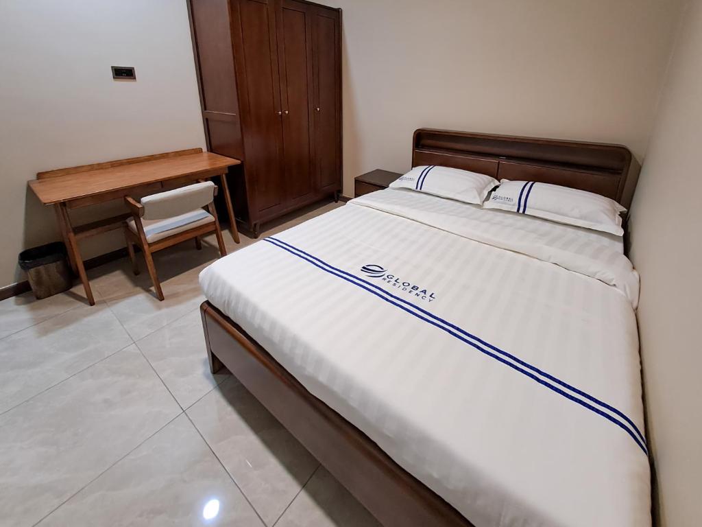 Postel nebo postele na pokoji v ubytování Global Residency