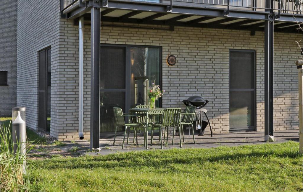a patio with a table and chairs in front of a building at Beach Front Apartment In Lembruch-dmmer See With Kitchenette in Lembruch