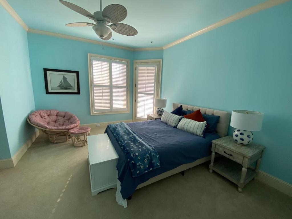 a bedroom with a bed and a ceiling fan at Vacation Retreat with Pool, Gym, Kitchen in Sugar Hill