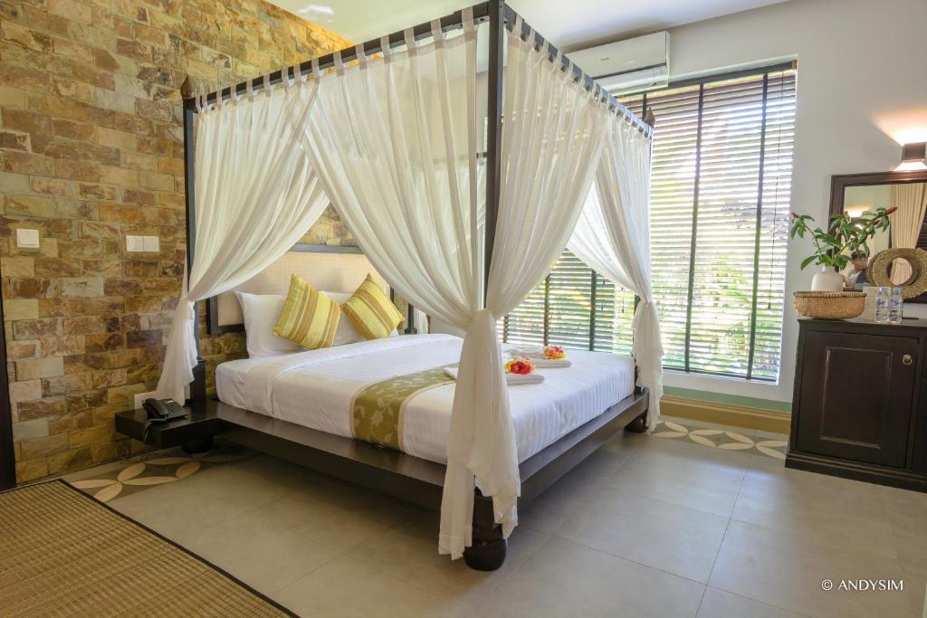 Postel nebo postele na pokoji v ubytování Samanea Beach Resort & Spa