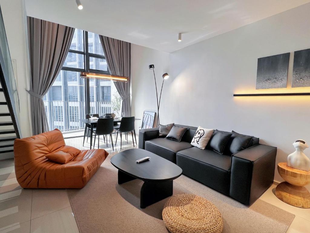 a living room with a couch and a table at EkoCheras Designer Suite by Moka @ Cheras in Kuala Lumpur