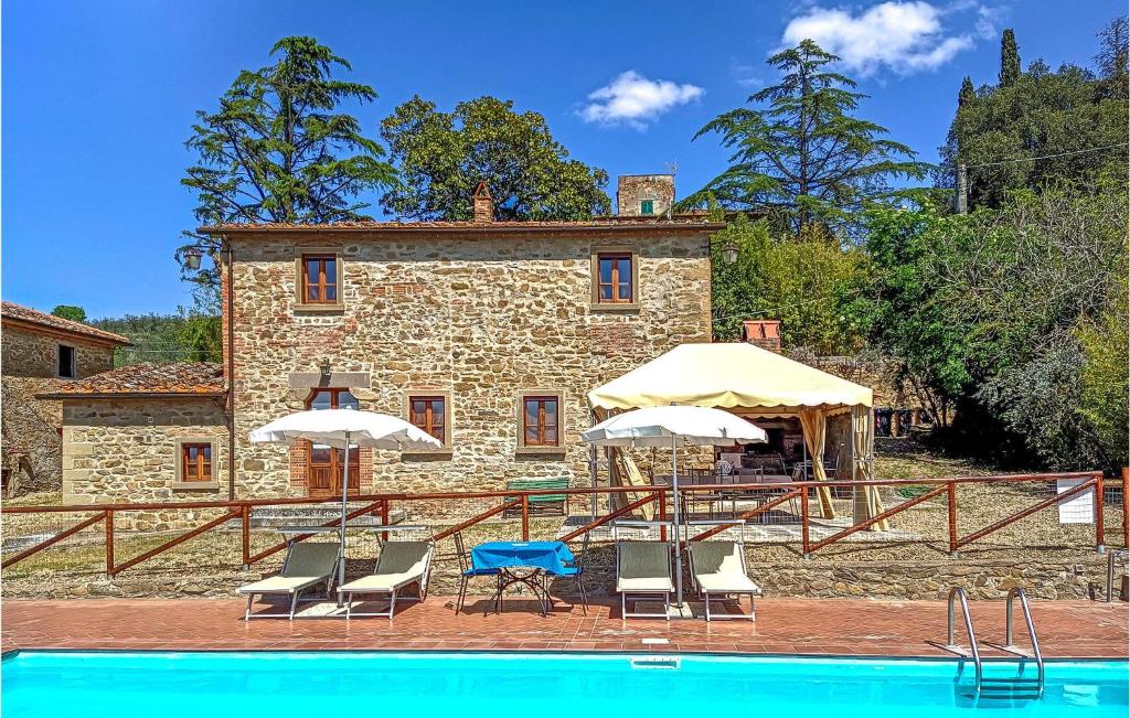 a house with a pool in front of a building at Beautiful Home In Castiglion Fiorentino With Kitchen in Pergognano