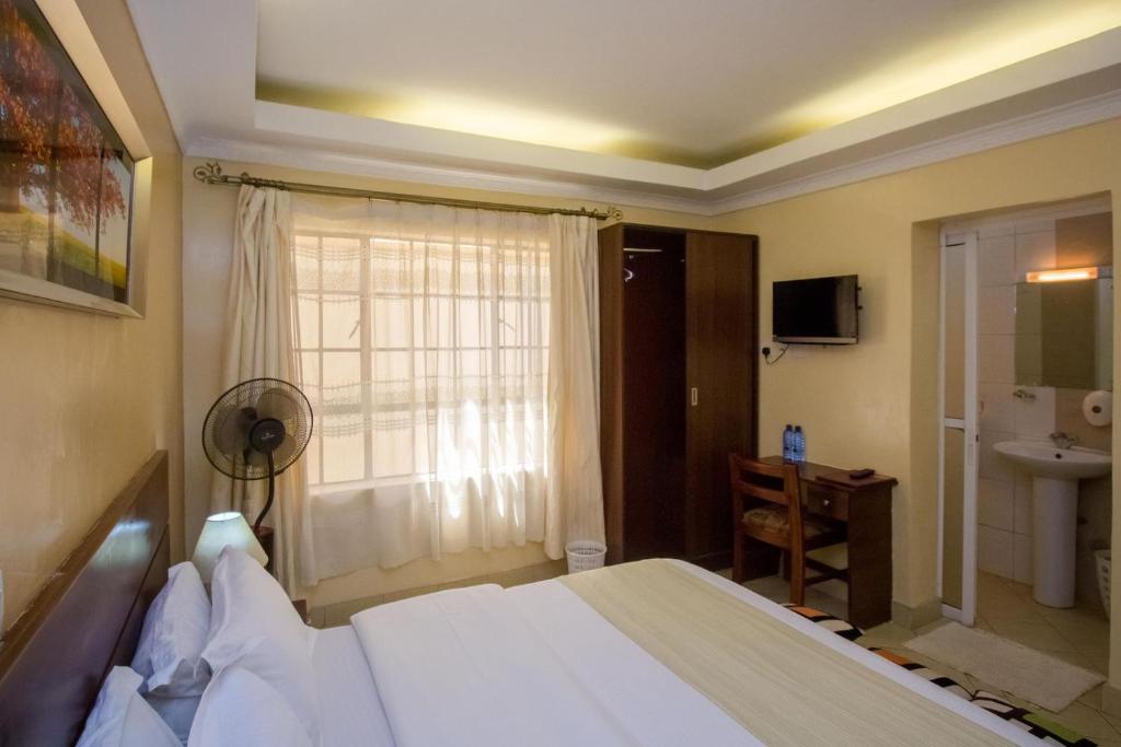 Postel nebo postele na pokoji v ubytování Capital Heights Hotel