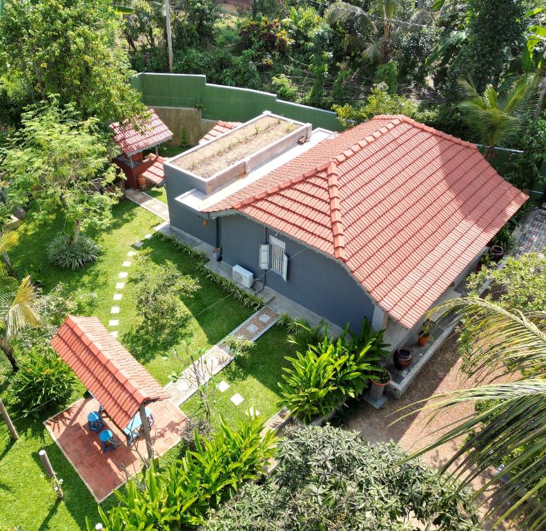 an aerial view of a house with an orange roof at Birdsong Villa in Rathgama