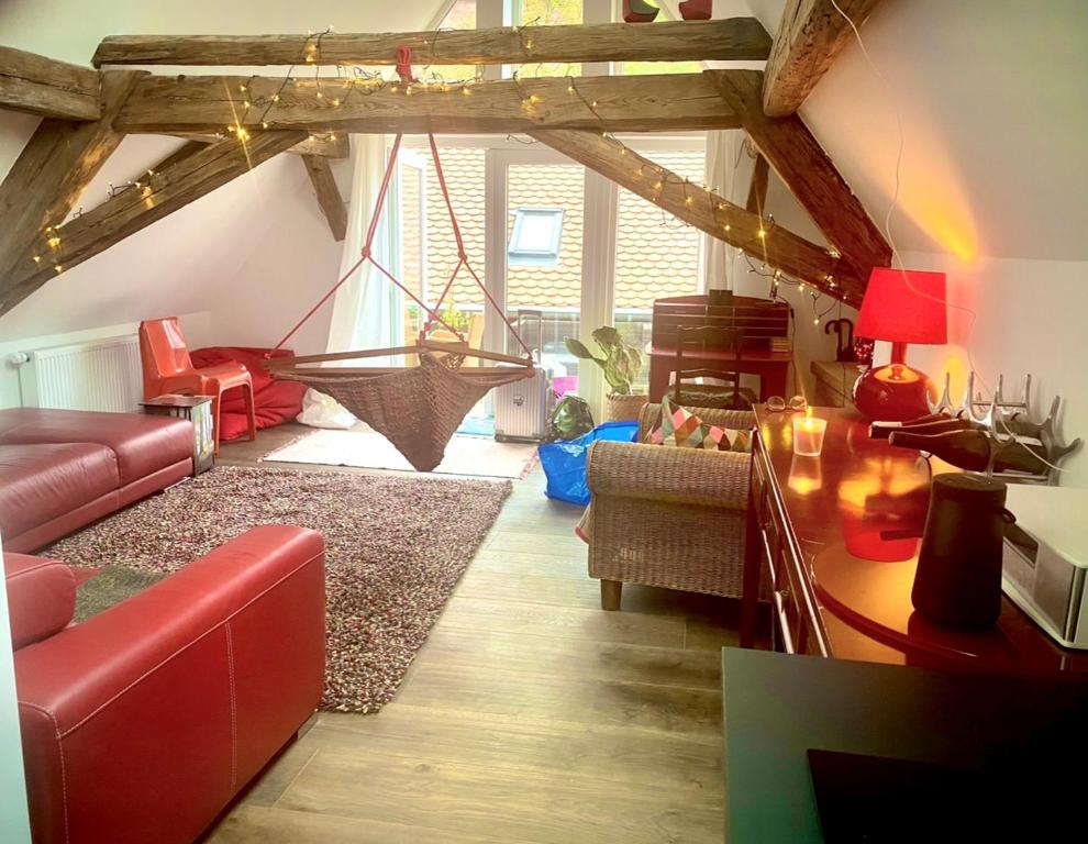 a living room with a red couch and a swing at Schönster Blick auf Oppenheim! in Oppenheim