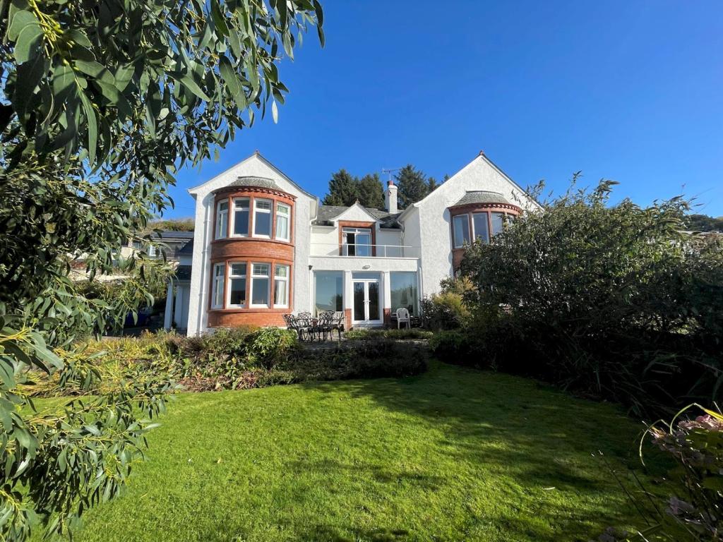 a large house with a lawn in front of it at Beautiful 4BR Period Home With Spectacular Views in Kippford