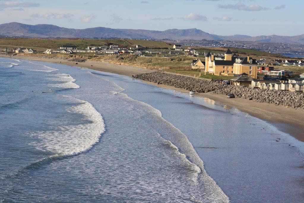 an aerial view of a beach with buildings and houses at Sandhouse Hotel in Rossnowlagh