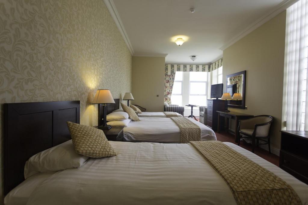 Postel nebo postele na pokoji v ubytování Sandhouse Hotel