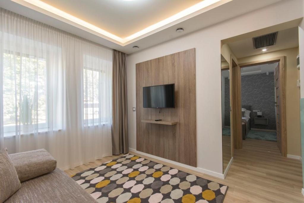 salon z telewizorem na ścianie w obiekcie PontJó Apartman Miskolc w Miszkolcu
