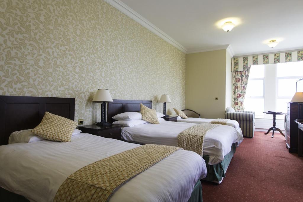 Postel nebo postele na pokoji v ubytování Sandhouse Hotel