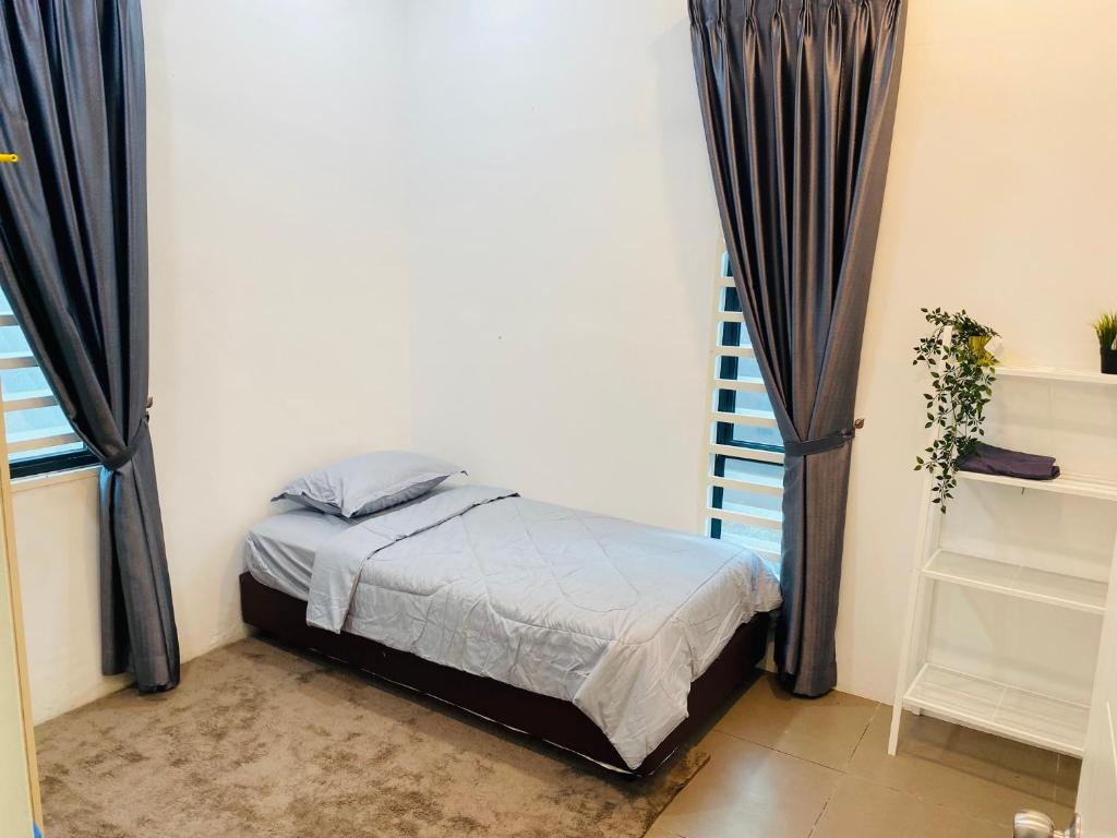 1 dormitorio con 1 cama en una habitación con cortinas en Homestay Alor Setar Nearby Hospital Sultanah Bahiyah en Alor Setar