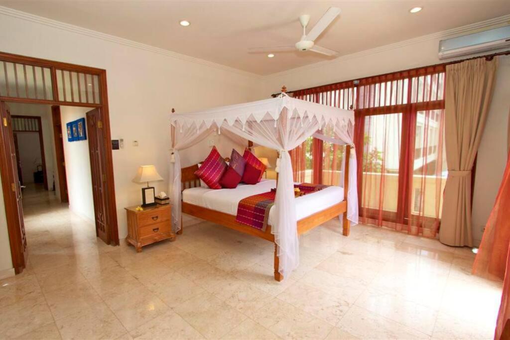 a bedroom with a bed with a canopy at Largest Villa in Kuta Royal C1 - Turquoise Villa in Kuta