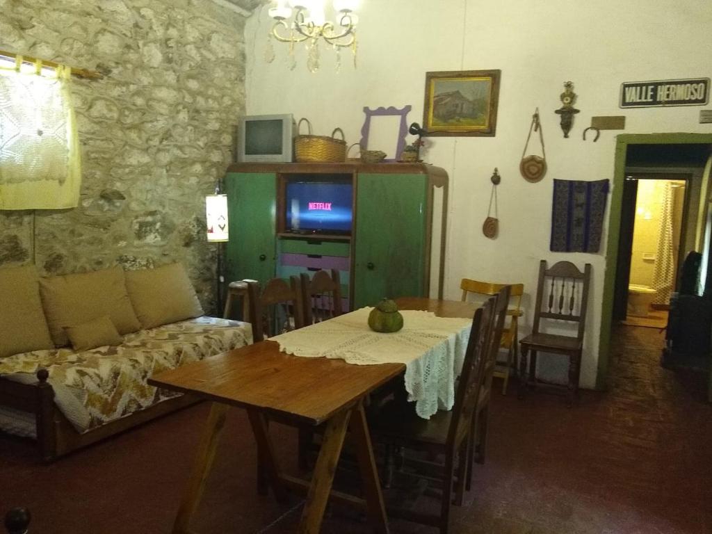 a living room with a table and a couch at La Casona del Río in Valle Hermoso