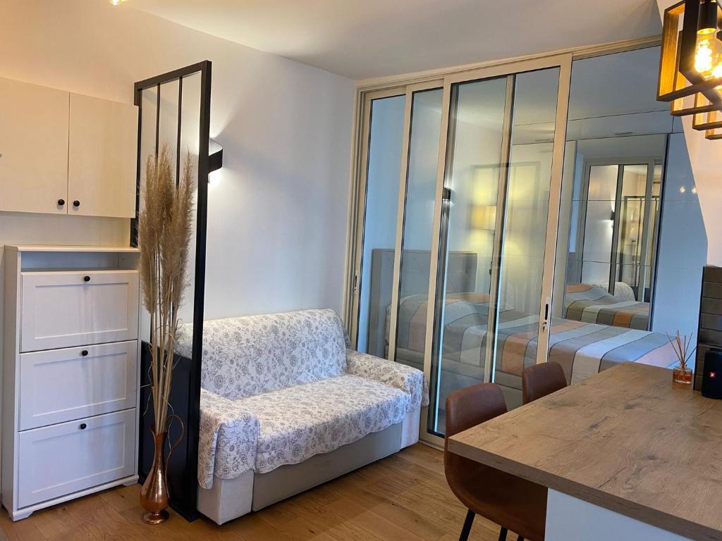 a bedroom with a table and a bedroom with a bed at Ollya in Paris